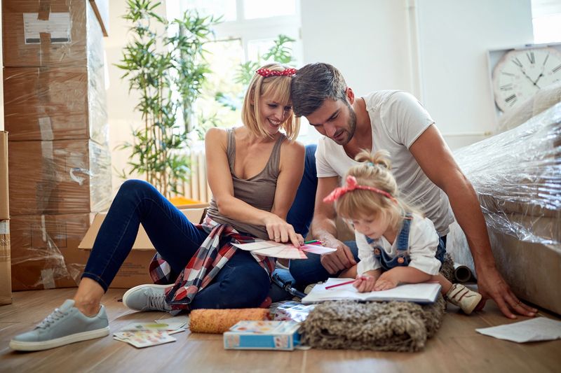 young family of three in new apartment. new apartment, new beginning, concept